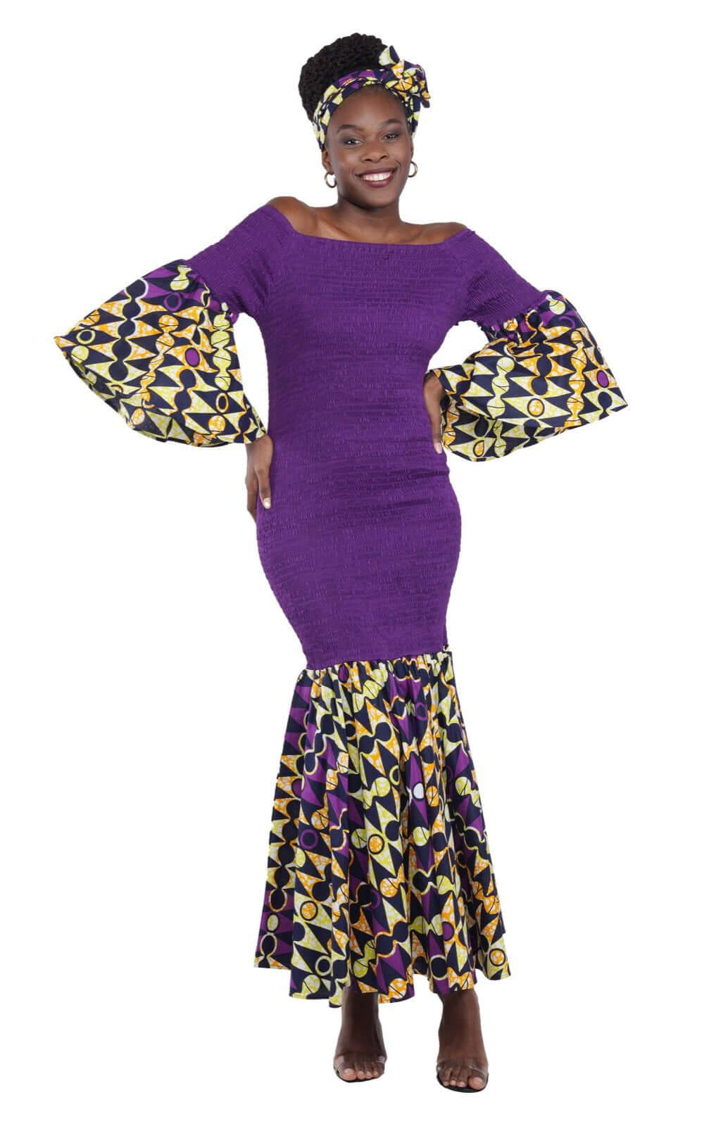 Woman wearing a purple long smoked fish tail dress with patterned sleeves and matching head wrap, theresa exotic style