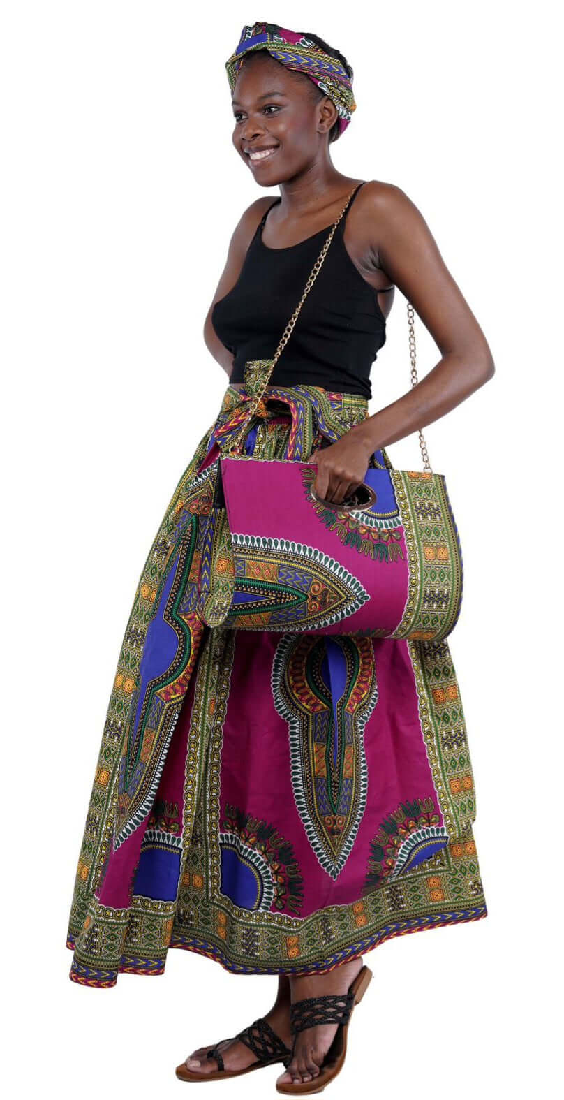 Woman wearing Dashiki long maxi skirt with two side pockets, matching head wrap, and purse from Theresa Exotic collection