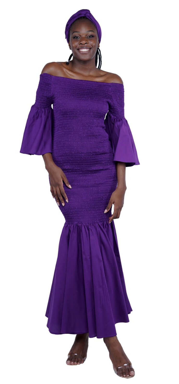 Woman wearing long purple fishtail dress with bell sleeves and matching head wrap, theresa exotic style